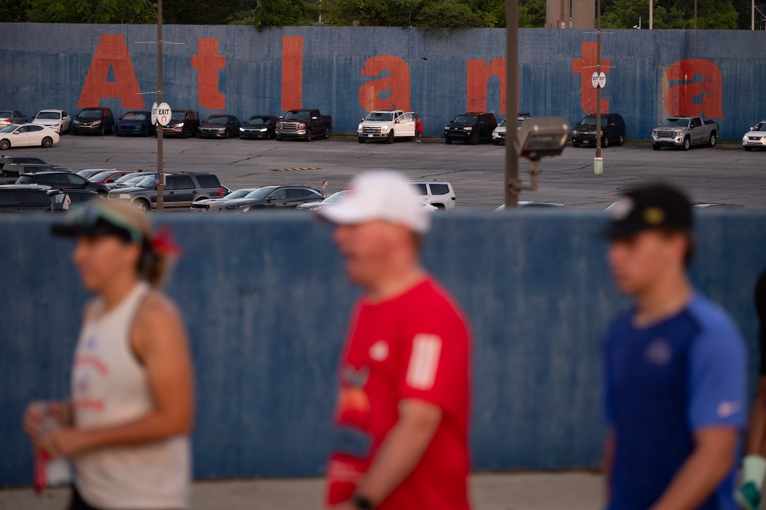 Runners walk past the location of the old Fulton County Stadium on their way to the MLB All-Star 4.4 Miler in Atlanta on Sunday, July 13, 2025. The 4.4 miles is a nod to Hank Aaron, who broke Babe Ruth’s home run record in Fulton County Stadium.  Ben Gray for the Atlanta Journal-Constitution