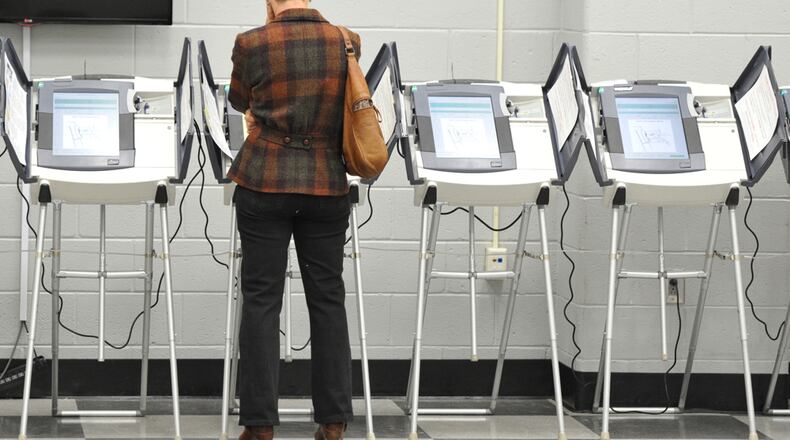 VOTE EARLY, NOT OFTEN--May 2, 2014 Atlanta - An early voter casts her ballot at Adamsville Recreation Center, an early voting site, in Atlanta on Friday, May 2, 2014. HYOSUB SHIN / HSHIN@AJC.COM