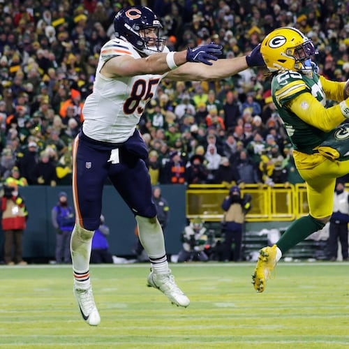 Green Bay Packers cornerback Keisean Nixon (25) intercepts a pass against Chicago Bears tight end Cole Kmet (85) during the second half of an NFL football game Sunday, Dec. 7, 2025, in Green Bay, Wis. (AP Photo/Matt Ludtke)