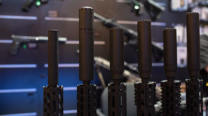 FILE - Firearms and suppressors are displayed at SHOT Show, the annual trade show for the gun industry, Jan. 21 2020, in Las Vegas. (AP Photo/Lisa Marie Pane, File)