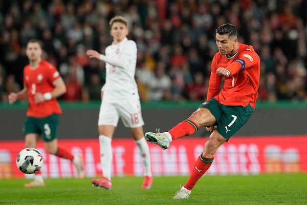 FILE - Portugal's Cristiano Ronaldo takes a shot during the UEFA Nations League soccer match between Portugal and Denmark, at the Jose Alvalade Stadium in Lisbon, March 23, 2025. (AP Photo/Armando Franca, File)