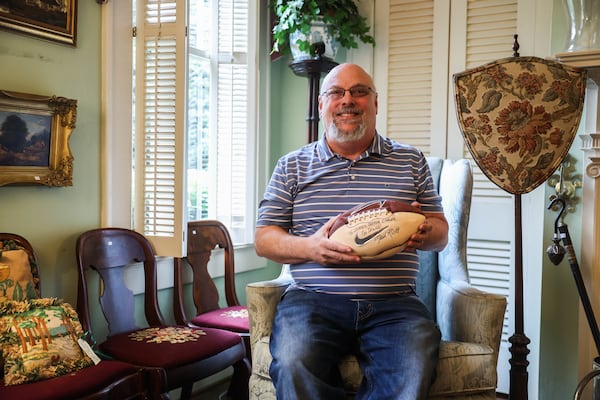 George Carley Jr. says this football, signed by former UGA head coach Mark Richt, was a prized possession for his father, former Georgia Supreme Court Chief Justice George Carley. (Abbey Cutrer/AJC)