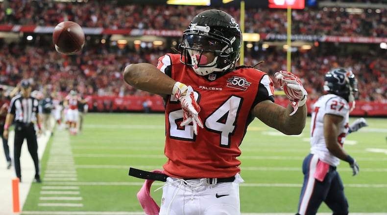 Falcons running back Devonta Freeman celebrates his first of three touchdowns on the day getting past Texans Quintin Demps for a 7-0 lead during the first quarter in a football game on Sunday, Oct. 4, 2015, in Atlanta.