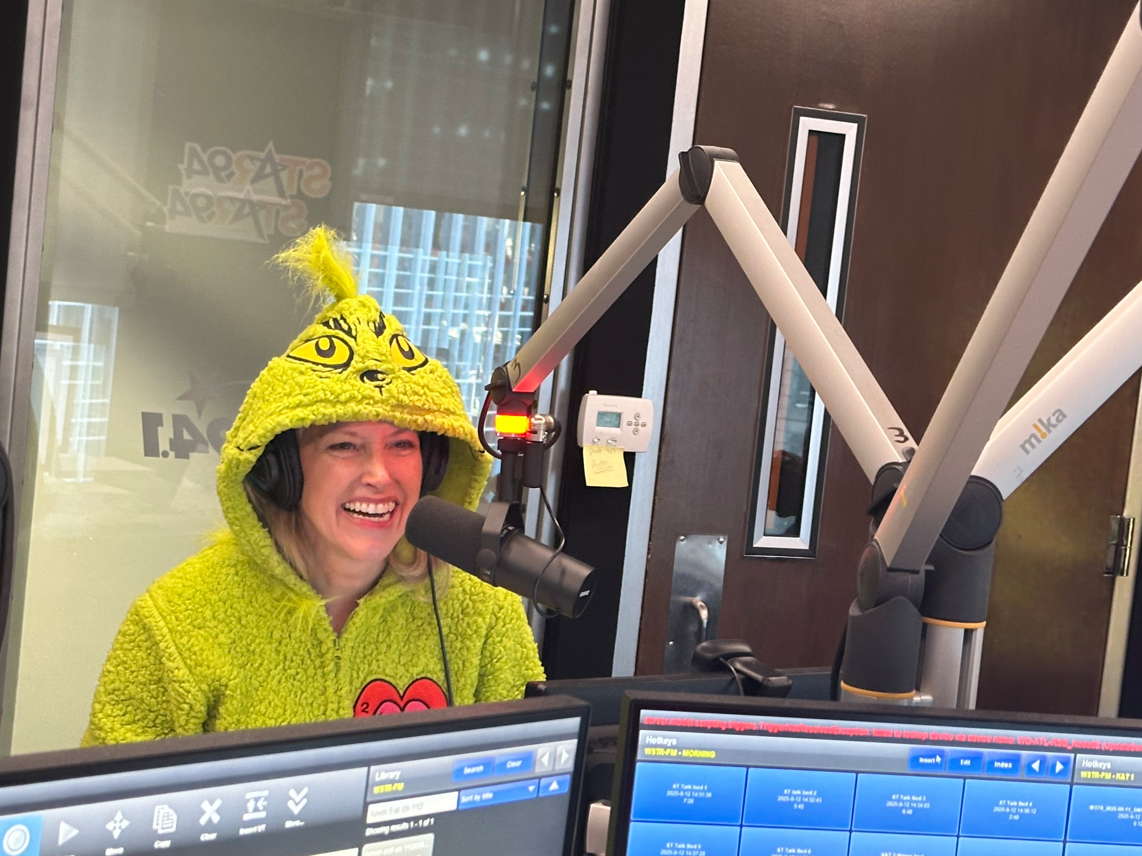 Taylor Scott, to celebrate going all Christmas on Star 94 Nov. 26, dressed up as the happy Grinch. (Rodney Ho/AJC)
