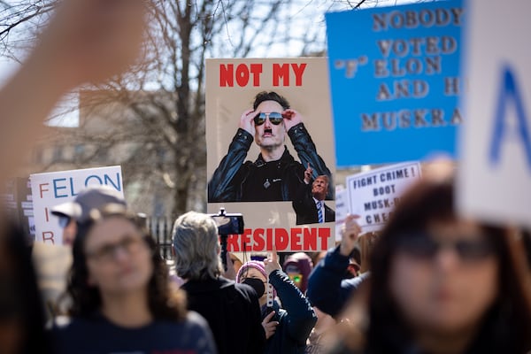 Demonstrators protest President Donald Trump and Elon Musk on Presidents Day in front of the Capitol in Atlanta on Monday, February 17, 2025, as part of nationwide demonstrations organized by the 50501 movement. (Arvin Temkar / AJC)