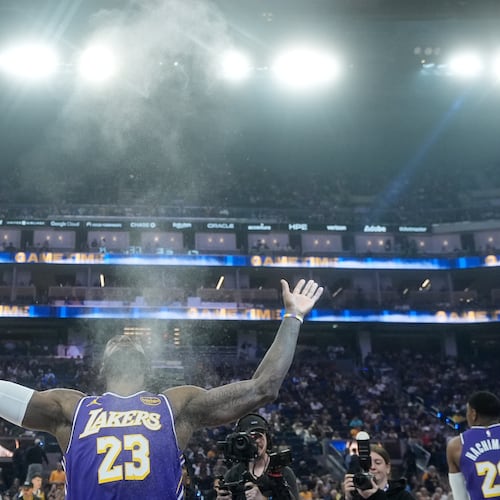FILE - Los Angeles Lakers forward LeBron James throws chalk in the air before an NBA basketball game against the Golden State Warriors in San Francisco, April 9, 2026. (AP Photo/Jeff Chiu, File)