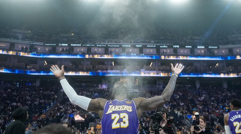 FILE - Los Angeles Lakers forward LeBron James throws chalk in the air before an NBA basketball game against the Golden State Warriors in San Francisco, April 9, 2026. (AP Photo/Jeff Chiu, File)