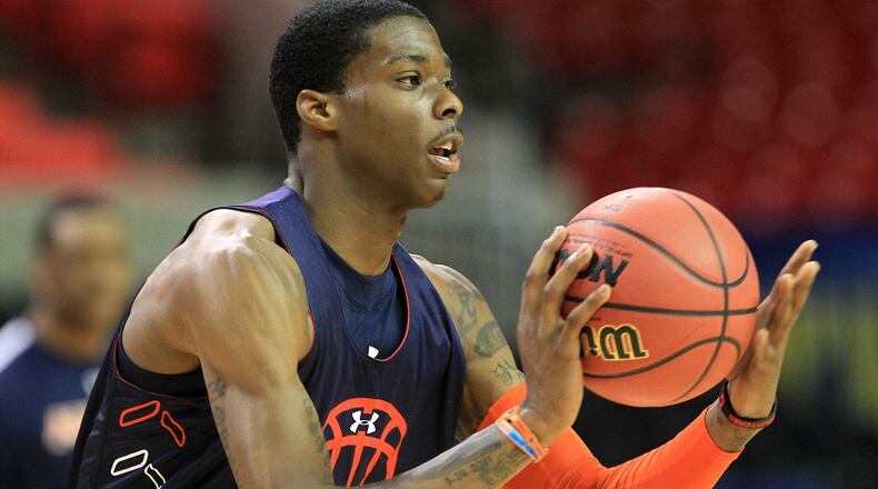 Auburn forward Kenny Gabriel looks to pass during his team's pre-tournament practice for the SEC Tournament at the Georgia Dome in Atlanta on Wednesday, March 9, 2011. Curtis Compton  ccompton@ajc.com