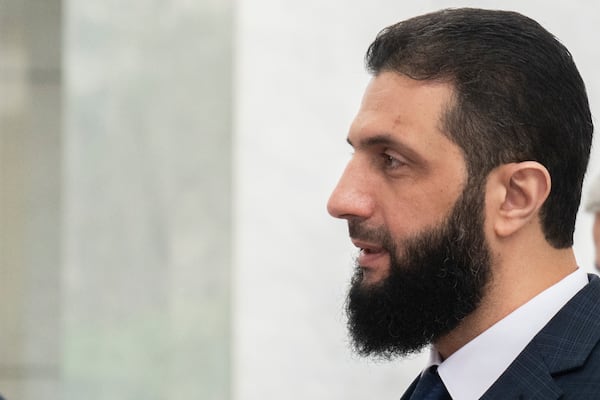 FILE - Syria's de facto leader, Ahmad al-Sharaa, walks in the presidential palace ahead of a meeting in Damascus, Dec. 28, 2024. (AP Photo/Mosa'ab Elshamy)