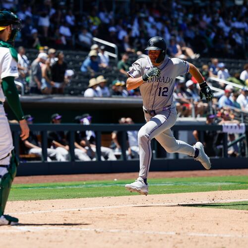 Colorado Rockies' Kyle Karros (12) runs home to score on a sacrifice fly by Braxton Fulford (37) during the fifth inning of a baseball game against the Athletics, Sunday, June 14, 2026, in Las Vegas. (AP Photo/Caroline Brehman)