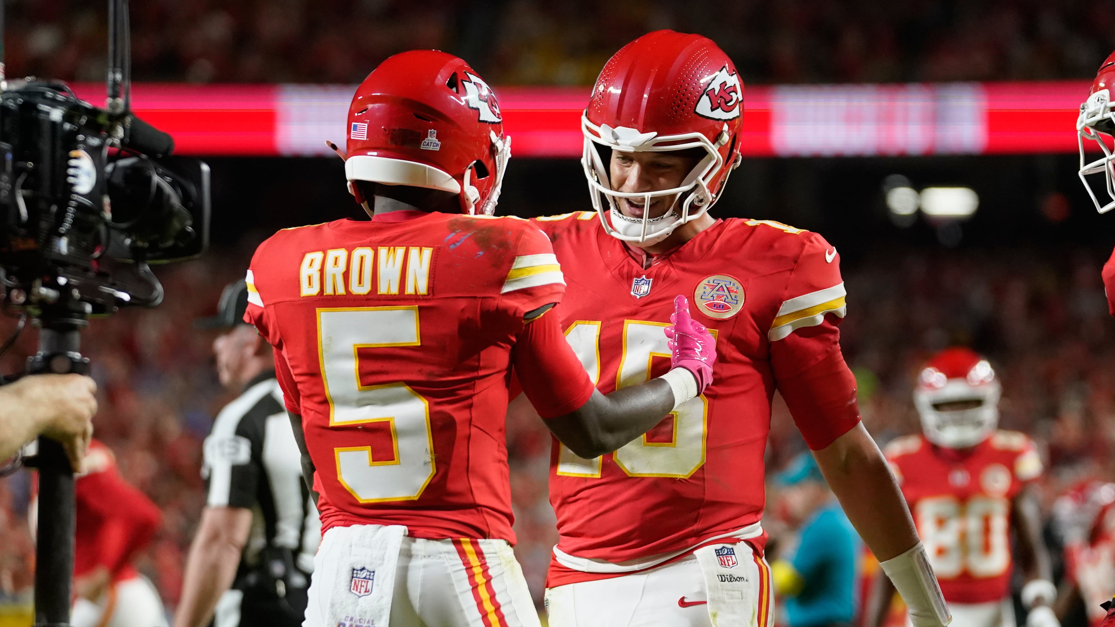 Kansas City Chiefs wide receiver Hollywood Brown (5) is congratulated by quarterback Patrick Mahomes (15) after scoring during the second half of an NFL football game against the Detroit Lions Sunday, Oct. 12, 2025, in Kansas City, Mo. (AP Photo/Ed Zurga)