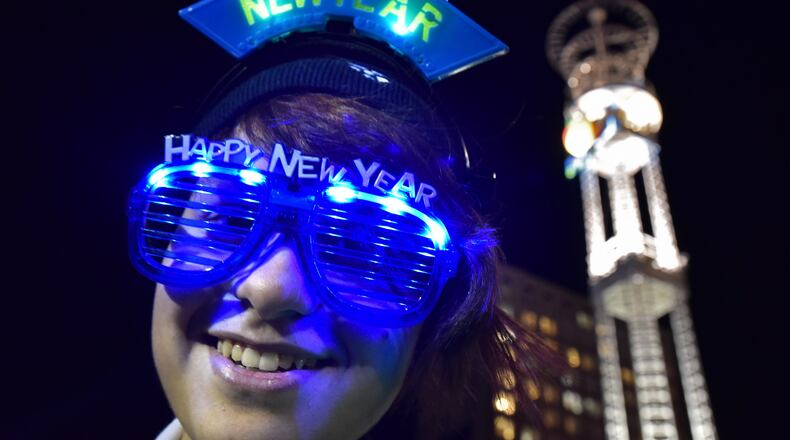 Daesum Butler, of Whitesburg, wears her New Year’s Eve glasses at Underground Atlanta during the 2015 New Year’s Eve Peach Drop. The music, fireworks and the descent of the 800-pound Peach that are traditionally part of the New Year’s Eve celebration at Underground may take place at Woodruff Park this year. HYOSUB SHIN / HSHIN@AJC.COM