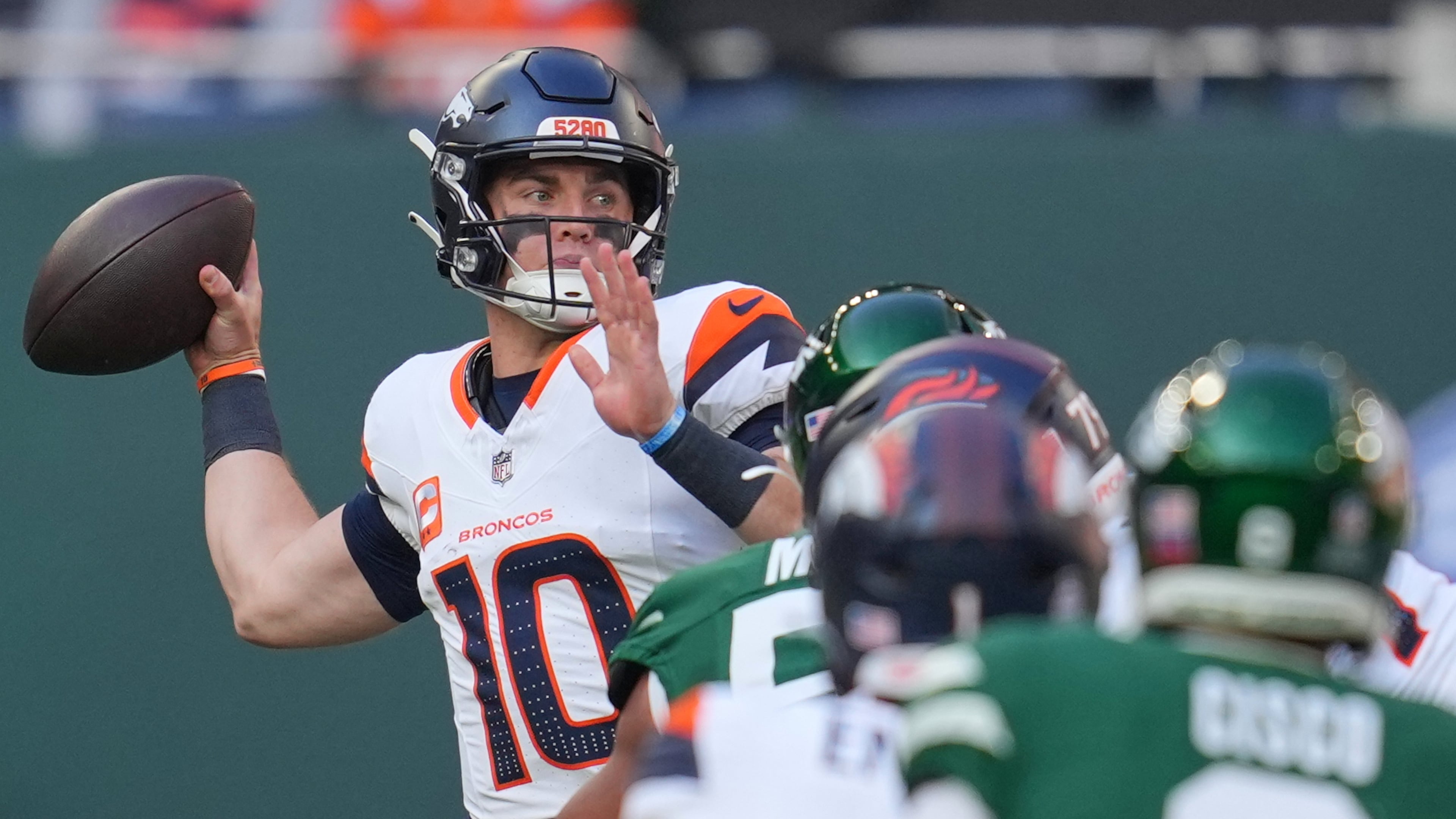 Denver Broncos quarterback Bo Nix passes the ball in the first half of an NFL football game between the Denver Broncos and the New York Jets, Sunday, Oct. 12, 2025, in London. (AP Photo/Kin Cheung)