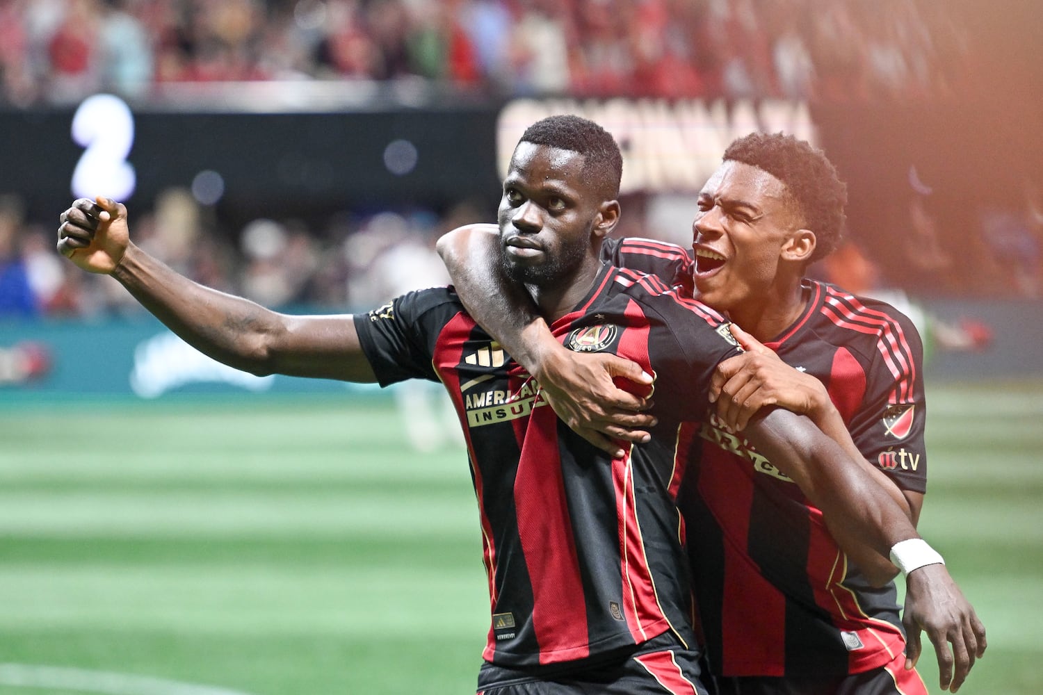Atlanta United forward Jamal Thiaré (14) celebrates his goal against FC Cincinnati’s with Atlanta United defender Matthew Edwards (47) in the  second half of a MLS soccer game Sunday, May 25, 2025 at the Mercedes-Benz Stadium. (Daniel Varnado/For the Atlanta Journal-Constitution)