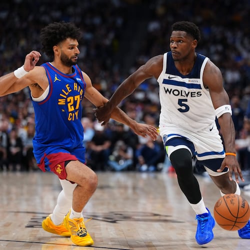 Minnesota Timberwolves guard Anthony Edwards (5) drives to the basket against Denver Nuggets guard Jamal Murray (27) during the second half in Game 2 of a first-round NBA playoffs basketball series Monday, April 20, 2026, in Denver. (AP Photo/Jack Dempsey)