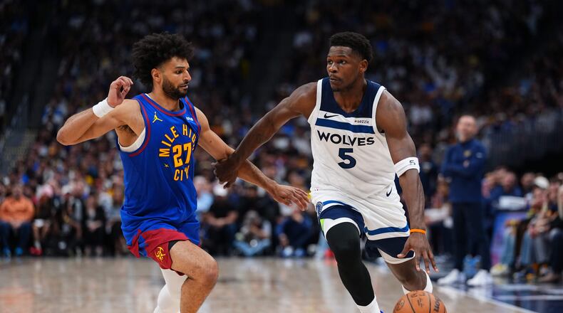 Minnesota Timberwolves guard Anthony Edwards (5) drives to the basket against Denver Nuggets guard Jamal Murray (27) during the second half in Game 2 of a first-round NBA playoffs basketball series Monday, April 20, 2026, in Denver. (AP Photo/Jack Dempsey)