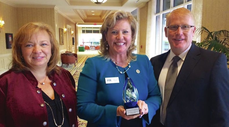 Lisa-Marie Haygood (center) of Cherokee County was congratulated by county School Board Chair Kyla Cromer (left) and Superintendent Brian V. Hightower (right) for winning the Georgia School Public Relations Association’s 2016 Outstanding Leadership in School-Community Relations award. Haygood lost her job this weekend as head of the state PTA organization in an apparent power struggle.