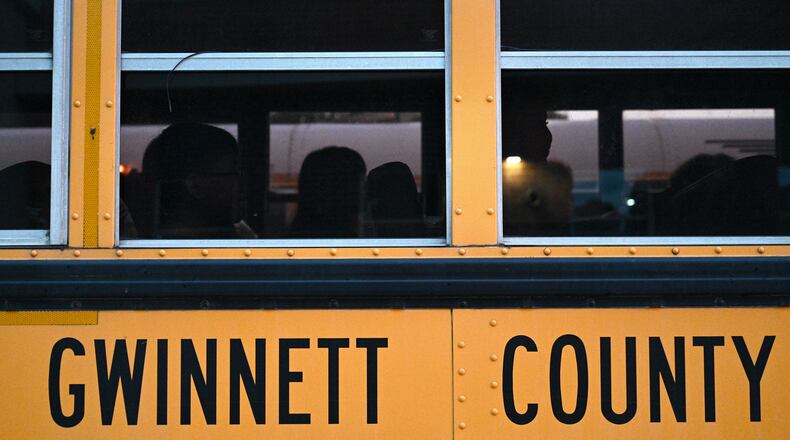 Students wait in the bus as they arrive for the first day of school at Seckinger High School in Buford on Wednesday, August 3, 2022. Gwinnett expects a revenue hit due to a newly expanded homestead exemption. (Hyosub Shin / Hyosub.Shin@ajc.com)