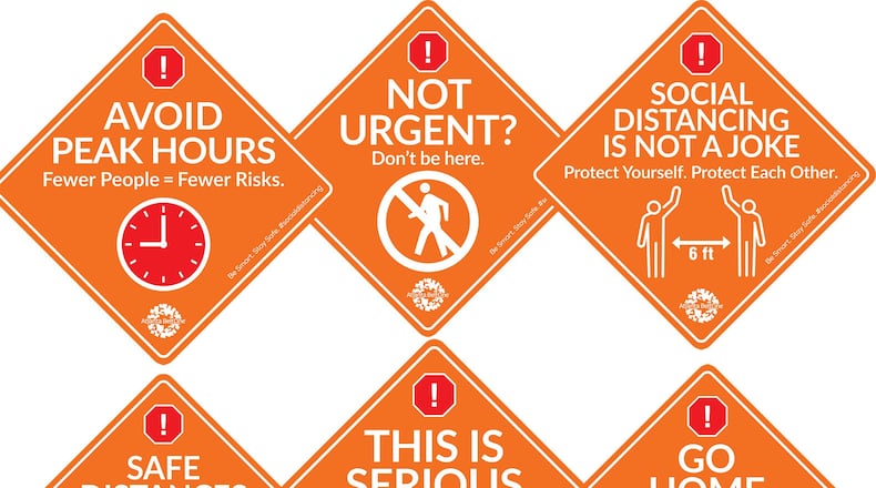 Signs along the Atlanta Beltline urge social distancing, caution during the coronavirus outbreak.