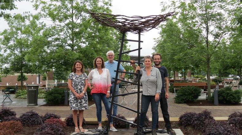 “La Voyageur Qui Fait Son Nid” is one of nine sculpture finalists in Sandy Springs' ArtSS in the Open Sculpture Competition. Pictured with the piece, installed at the City Green (from left): ArtSS board members Melissa Patterson, Bridgette Cunniff and Randy Young; artist Corrina Sephora, and Sephora’s studio assistant Richard Pepe.