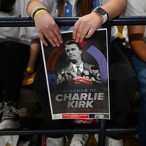 An attendee holds a poster of Charlie Kirk at a Turning Point USA rally at Utah State University, as a part of the organization's push to memorialize Kirk, Tuesday, Sept. 30, 2025, in Logan, Utah. (AP Photo/Alex Goodlett)