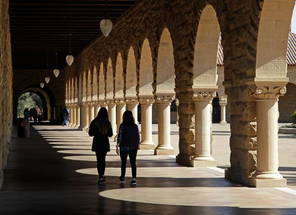 FILE - Students walk on the Stanford University campus, March 14, 2019, in Santa Clara, Calif. (AP Photo/Ben Margot, File)