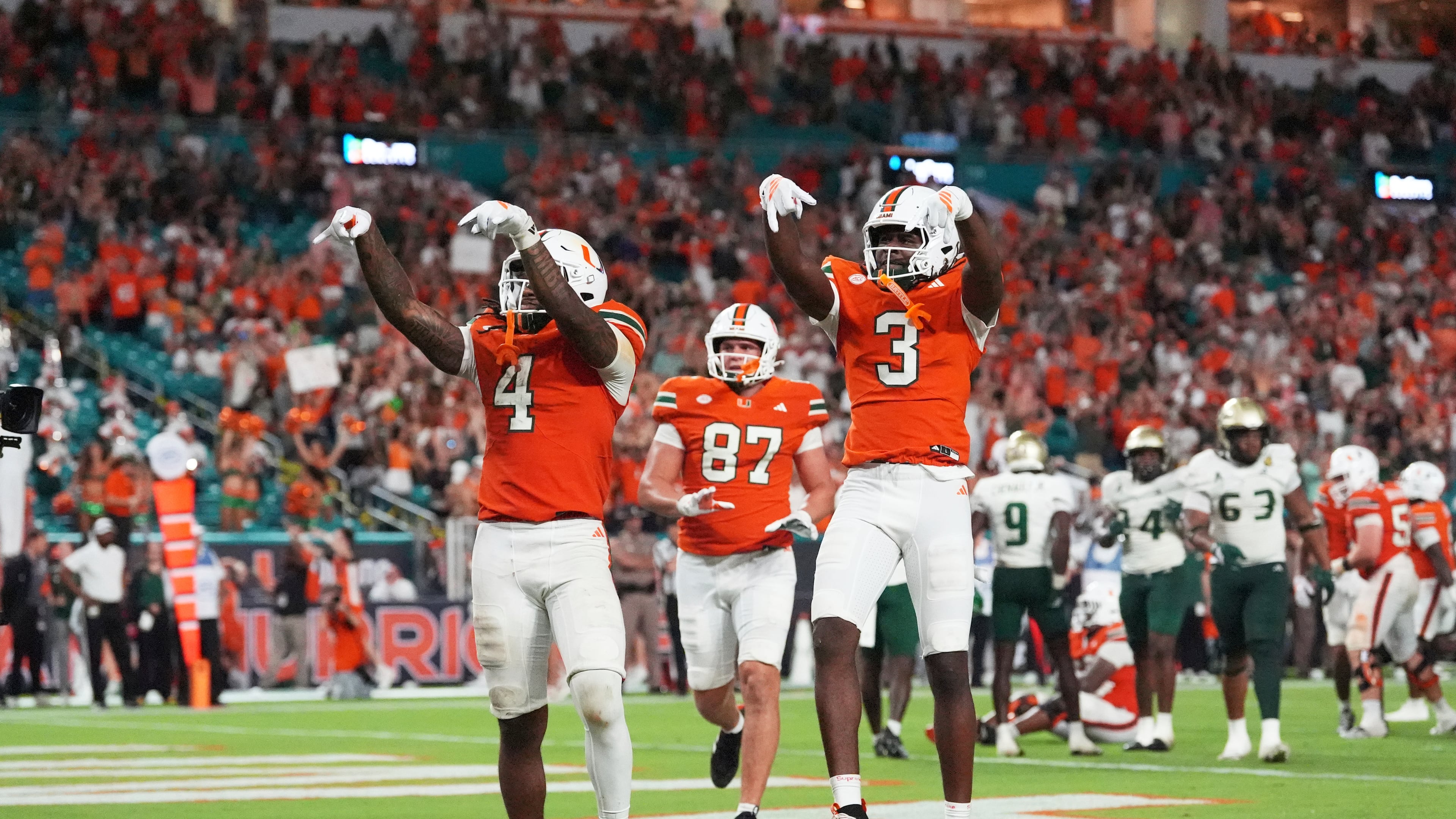 Miami Hurricanes running back Mark Fletcher Jr. (4) celebrates with Miami Hurricanes wide receiver Joshua Moore (3) after scoring a touchdown during the second half of an NCAA college football game against South Florida, Saturday, Sept. 13, 2025, in Miami Gardens, Fla. (AP Photo/Rebecca Blackwell)