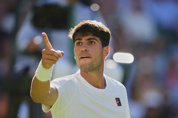 Carlos Alcaraz of Spain reacts after breaking the serve of Fabio Fognini of Italy during their first round men's singles match at the Wimbledon Tennis Championships in London, Monday, June 30, 2025. (AP Photo/Alastair Grant)