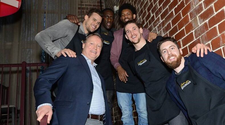 Hawks coach Mike Budenholzer with players Kris Humphries, Taurean Prince, DeAndre Bembry, Mike Muscala and Ryan Kelly at a recent dinner to raise money for the Atlanta Community Food Bank. Photo provided.