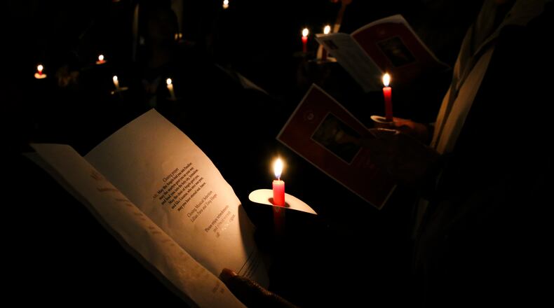 Commemorators hold candles and read the name of people who died while homeless at a 2019 vigil hosted by Mercy Care, an affordable health center in Atlanta. Mercy Care will hold its 16th annual vigil on Dec. 21 to mark National Homeless Persons Memorial Day, which began in 1990 by the National Coalition for the Homeless and the National Health Care for the Homeless Council.