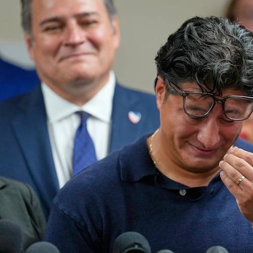 Ronaldo Salgado, son of Lorenzo Salgado Araujo, wipes away tears while speaking during a news conference Wednesday, July 8, 2026, in Houston. (AP Photo/David J. Phillip)