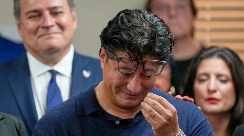 Ronaldo Salgado, son of Lorenzo Salgado Araujo, wipes away tears while speaking during a news conference Wednesday, July 8, 2026, in Houston. (AP Photo/David J. Phillip)