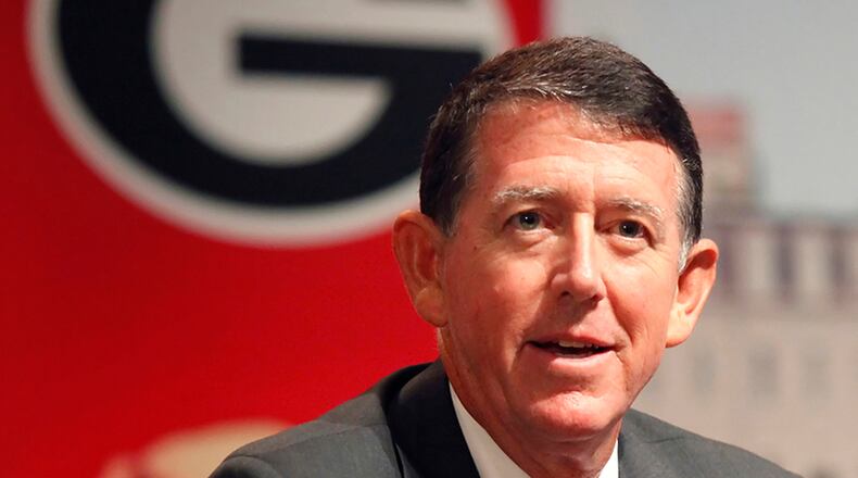 Greg McGarity (R) talks to UGA President Jere Morehead before Georgia’s basketball game against Norfolk State earlier this year. (UGA photo by John Kelley)