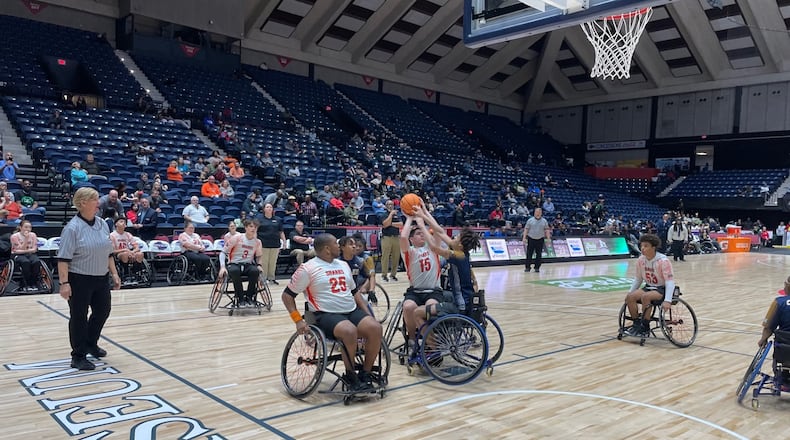 Houston County's Anthony Cuti (15) is defended by Clayton County's Edward Rhone (in blue) during Houston County's 35-16 victory in the wheelchair basketball state championship game at the Macon Coliseum on March 9, 2024.