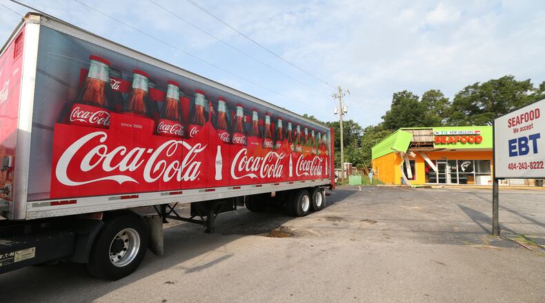 A Candler Road seafood restaurant was damaged Friday morning when a delivery truck ran into the front of the building. JOHN SPINK/JSPINK@AJC.COM