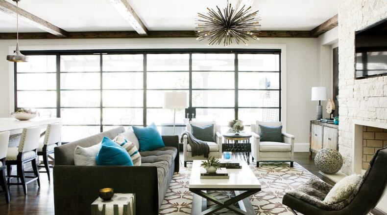 In this new home near Atlanta’s Chastain Park, designer Brian Watford designed a space for a father and his two young children. In the combination living room and kitchen, the sliding iron and glass doors open up to outdoor space. Contributed by Erica George Dines