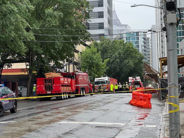 Police and fire crews are seen in Midtown following a partial crane collapse Monday afternoon.