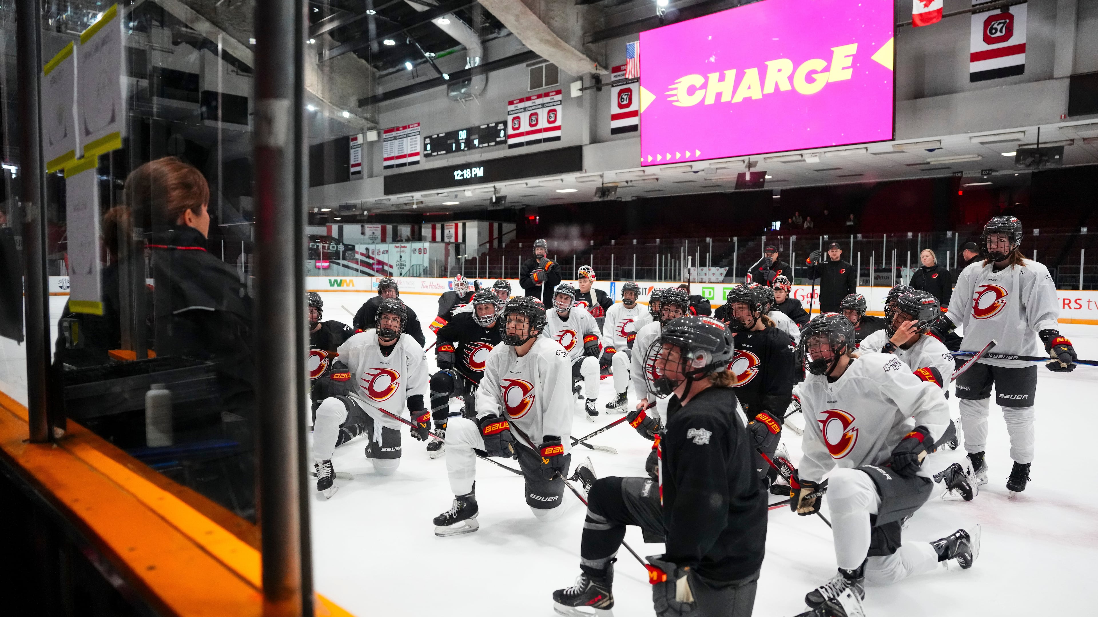 Ottawa Charge head coach Carla MacLeod, left, speaks to her team during PWHL hockey training camp, Wednesday, Nov. 12, 2025, in Ottawa, Ontario (Sean Kilpatrick/The Canadian Press via AP)