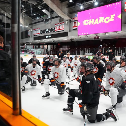 Ottawa Charge head coach Carla MacLeod, left, speaks to her team during PWHL hockey training camp, Wednesday, Nov. 12, 2025, in Ottawa, Ontario (Sean Kilpatrick/The Canadian Press via AP)
