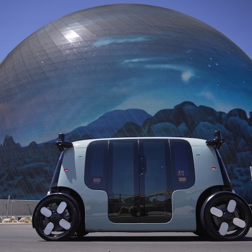An Amazon Zoox taxi with no steering wheel drives in front of The Sphere on the Las Vegas strip, Thursday, July 30, 2026. (AP Photo/Ty ONeil)