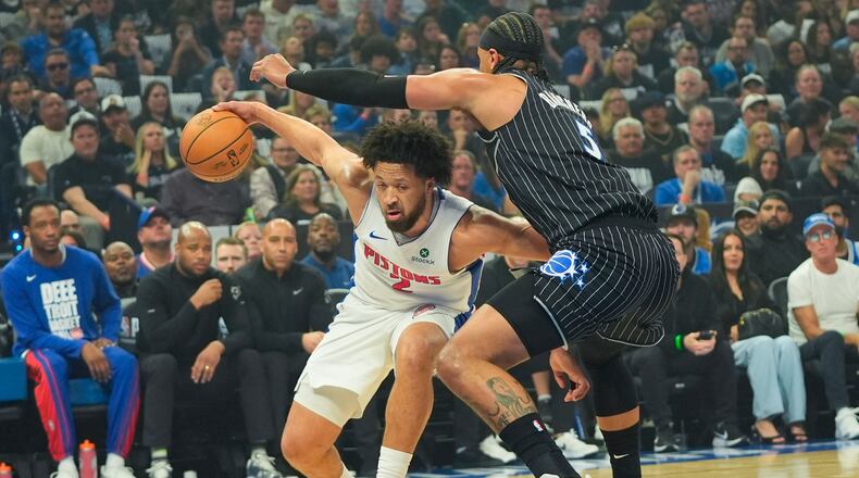 Detroit Pistons guard Cade Cunningham, left, tires to get past Orlando Magic forward Paolo Banchero, right, during the first half in Game 6 of a first-round NBA basketball playoffs series, Friday, May 1, 2026, in Orlando, Fla. (AP Photo/John Raoux)