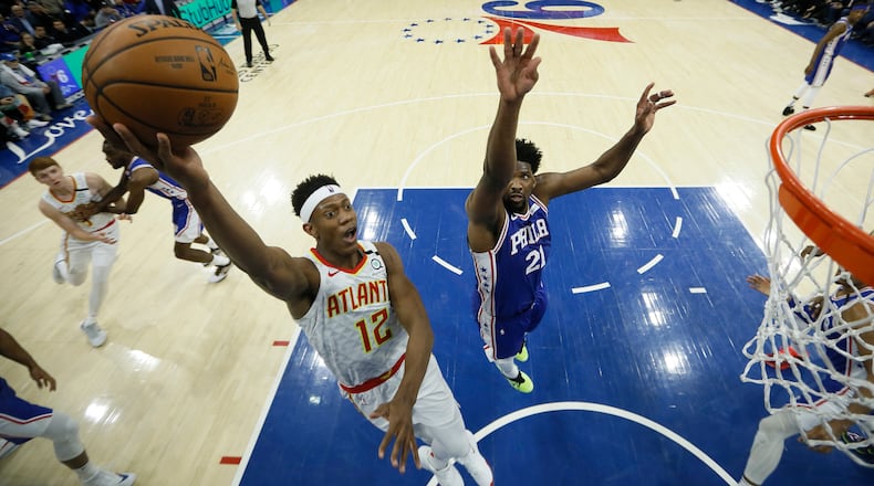 Hawks forward De'Andre Hunter looks to shoot while Sixers center Joel Embiid defends. (AP Photo/Matt Slocum)