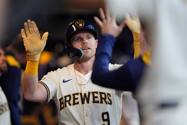 Milwaukee Brewers' Jake Bauers is congratulated in the dugout after hitting a solo home run during the sixth inning of a baseball game against the Atlanta Braves, Tuesday, June 10, 2025, in Milwaukee. (AP Photo/Aaron Gash)
