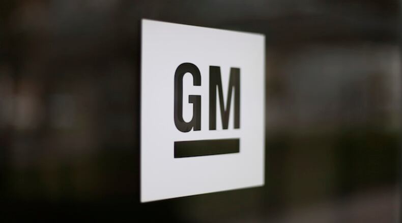 This Friday, May 16, 2014, file photo, shows the General Motors logo at the company's world headquarters in Detroit. In another tweet targeting GM, President-elect Donald Trump is threatening to slap a tax on the U.S. automaker for importing compact cars to the U.S. from Mexico. But GM makes the vast majority of compact Chevrolet Cruzes at a sprawling factory complex in Lordstown, Ohio, near Cleveland. (AP Photo/Paul Sancya, File)