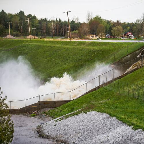 FILE - Water rushes through the Edenville Dam, May 19, 2020, in Edenville, Mich. (Katy Kildee/Midland Daily News via AP, File)