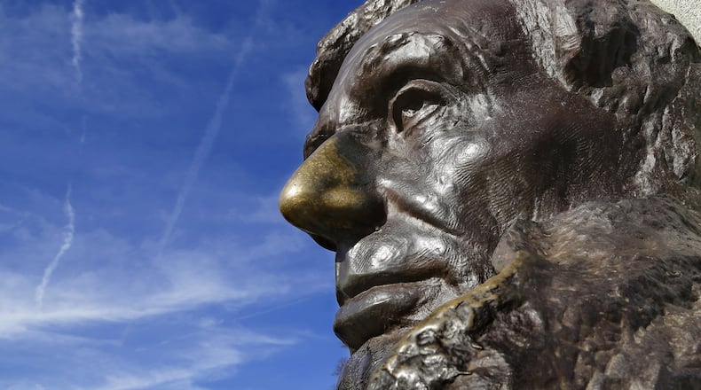 A bust of the Abraham Lincoln statue looks out over visitors at Lincoln’s tomb within Oak Ridge Cemetery in Springfield, Ill. (AP Photo/Seth Perlman, File)