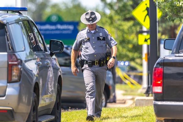 Law enforcement members respond to a shooting on Terminal Drive near the Blue Grass Airport in Lexington, Ky., Sunday, July 13, 2025. (Ryan C. Hermens/Lexington Herald-Leader via AP)