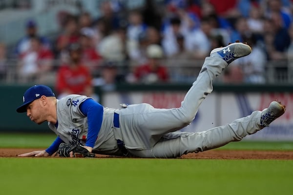 Los Angeles Dodgers first baseman Freddie Freeman (5) makes a catch off the Atlanta Braves in the third inning of a baseball game, Friday, May 2, 2025, in Atlanta. (AP Photo/Mike Stewart)