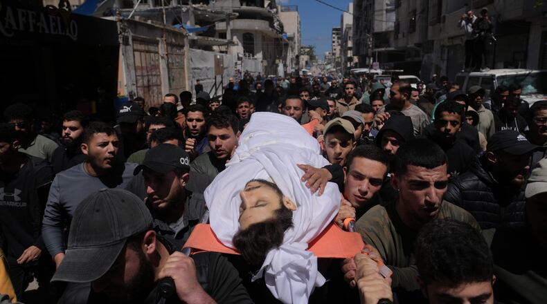 Mourners carry the body of Azzam al-Hayya, son of Hamas leader Khalil al-Hayya, mourn over his body after he was killed in an Israeli airstrike, at Shifa Hospital in Gaza City Thursday, May 7, 2026. (AP Photo/Jehad Alshrafi)