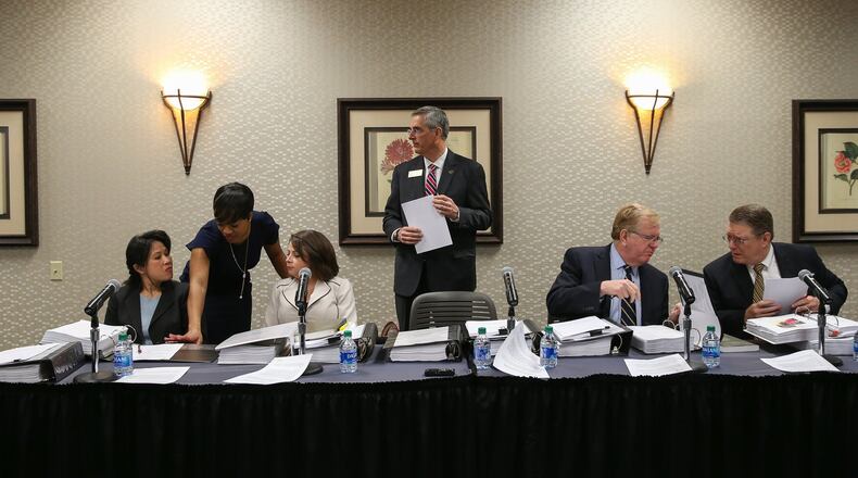 State Election Board members prepare for an emergency hearing held at the Georgia Center for Continuing Education in Athens on Wednesday, March 11, 2020. Secretary of State Brad Raffensperger is standing, surrounded by seated board members from left: Anh Le, Rebecca Sullivan, David Worley and Mathew Mashburn. (Photo/Austin Steele for The Atlanta Journal Constitution)